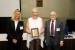 Prof. Suzanne Lunsford and Dr. Nagib Callaos giving Dr. Christin Lindholm a plaque "In Appreciation for Delivering a Great Keynote Address at a Plenary Session."